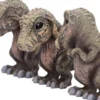 Drei weise T-Rex Figuren: Nichts sehen, nichts hören, nichts sagen